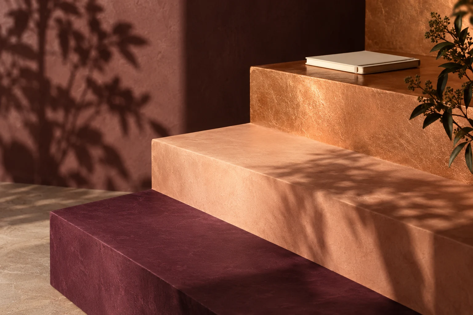Sculptural plum and peach steps with a notebook